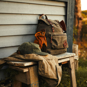 Black leather backpack with waxed canvas roll to close top and leather  front pocket